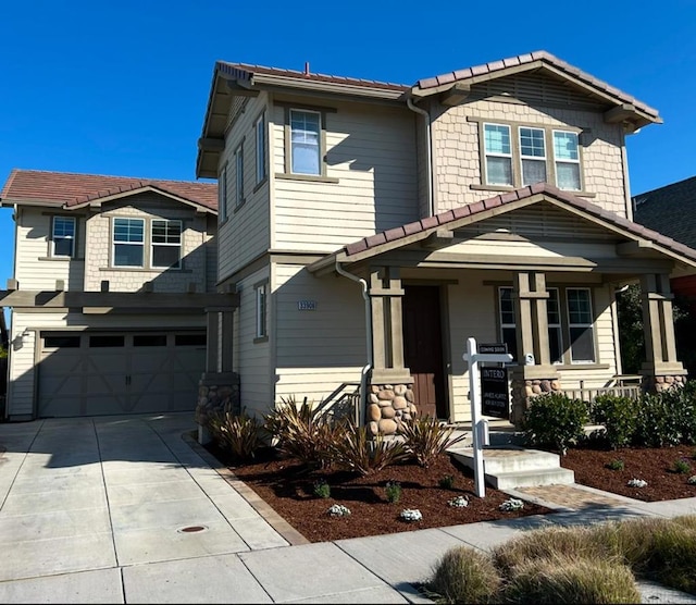 craftsman-style home featuring a garage and covered porch