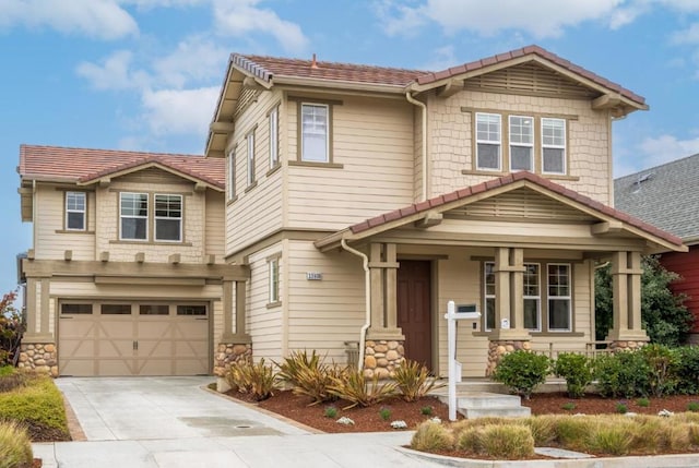 craftsman-style house featuring a porch and a garage