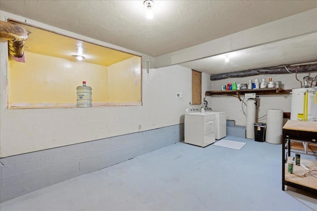 basement with water heater and washing machine and clothes dryer