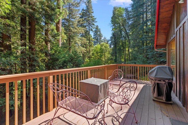 wooden terrace with a grill