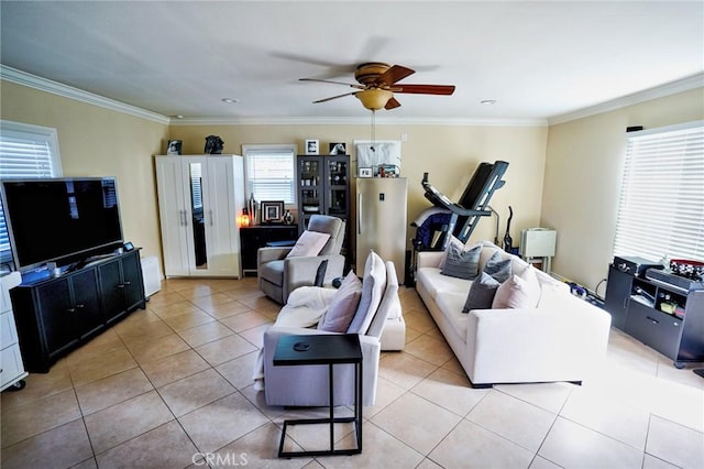 tiled living room featuring ceiling fan, ornamental molding, and a wealth of natural light