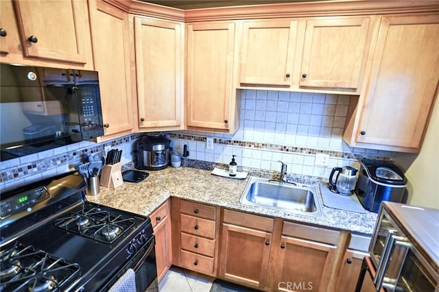 kitchen with tasteful backsplash, sink, black appliances, and light tile patterned flooring