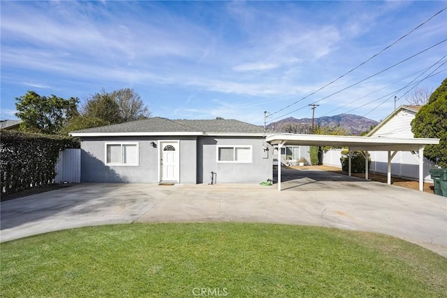 view of front facade with a carport and a front yard