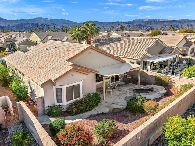 exterior space featuring a mountain view and a patio area