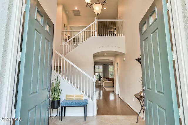 foyer entrance with a towering ceiling