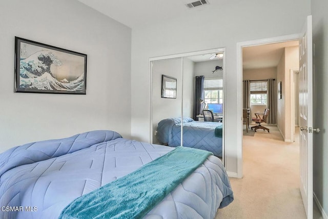 bedroom with light colored carpet and a closet