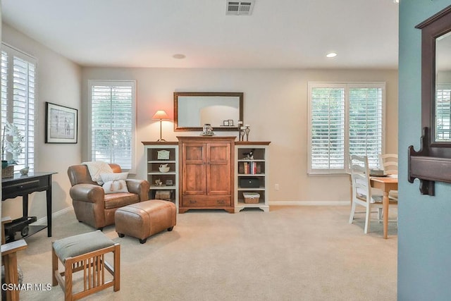 living area with light colored carpet