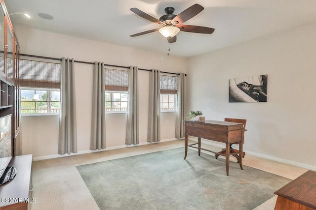 carpeted home office with ceiling fan