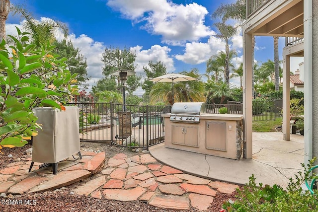 view of patio featuring area for grilling and a grill