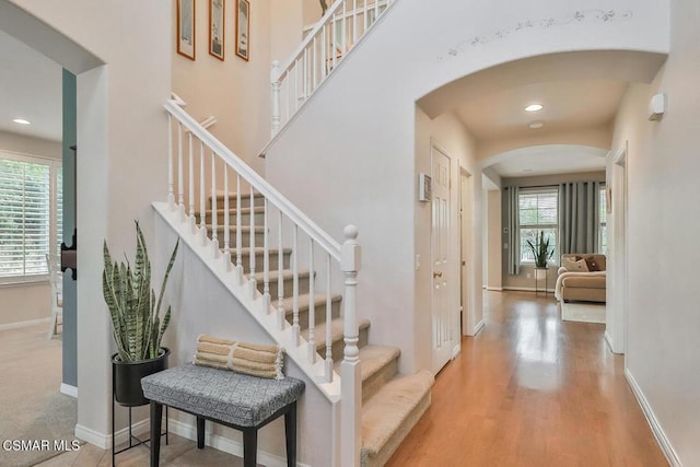 stairs featuring hardwood / wood-style floors