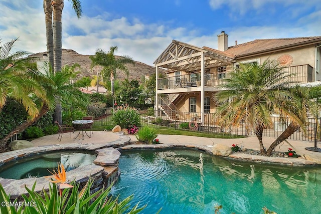 view of swimming pool with an in ground hot tub and a patio