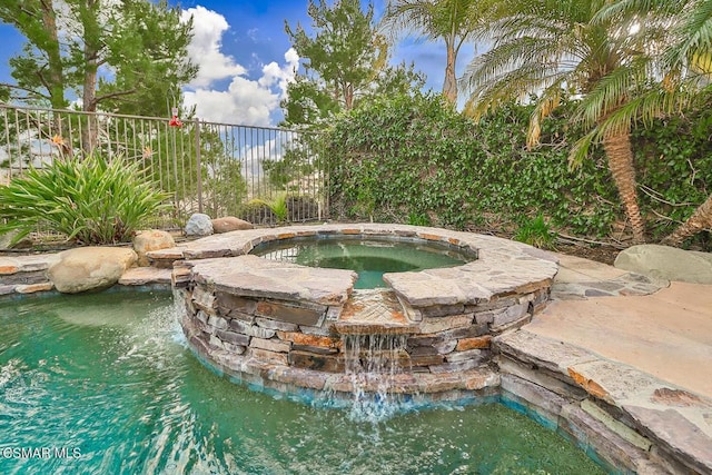 view of pool featuring an in ground hot tub