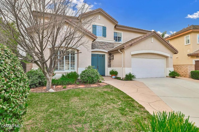 front of property with a garage and a front lawn