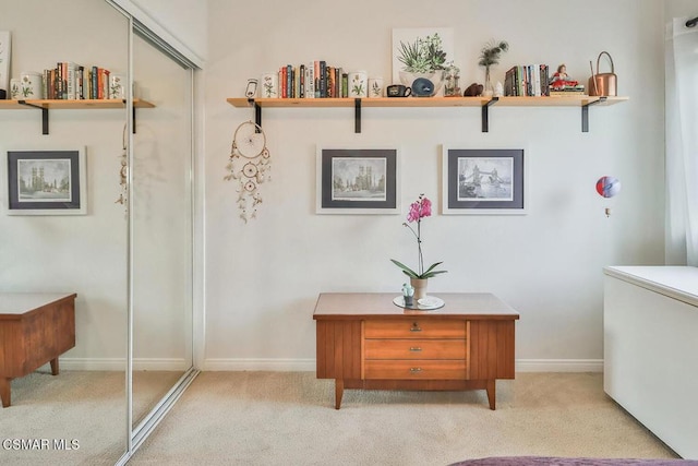 hall featuring light colored carpet