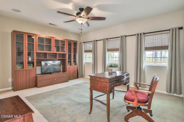 carpeted office with ceiling fan