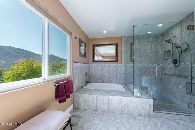 bathroom featuring a mountain view and independent shower and bath