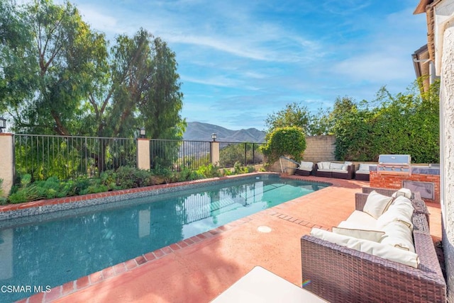 view of swimming pool featuring a patio area, area for grilling, grilling area, outdoor lounge area, and a mountain view