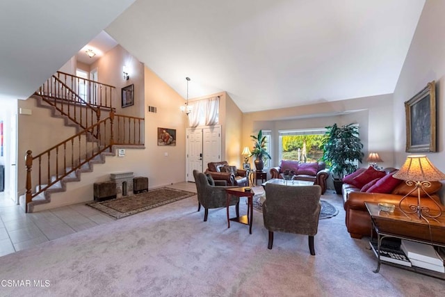 carpeted living room featuring a chandelier and high vaulted ceiling