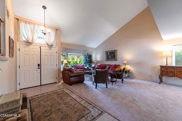 tiled entrance foyer featuring a chandelier and high vaulted ceiling