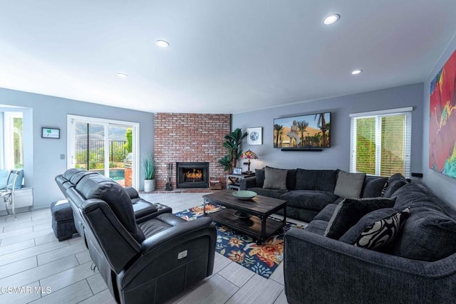 living room featuring a fireplace and a wealth of natural light