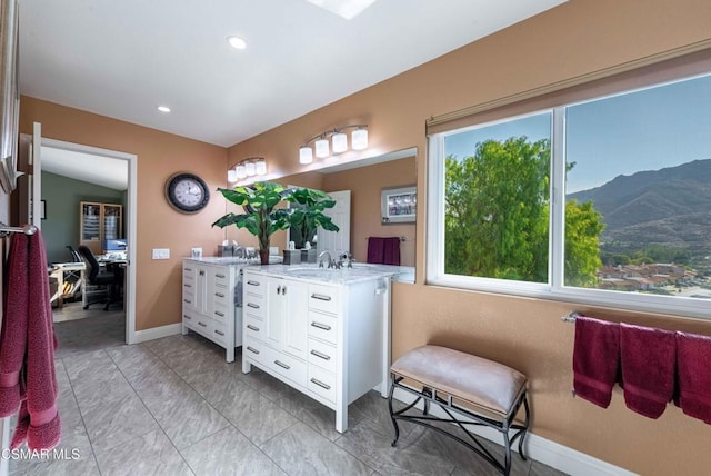 bathroom with vanity, a mountain view, and vaulted ceiling