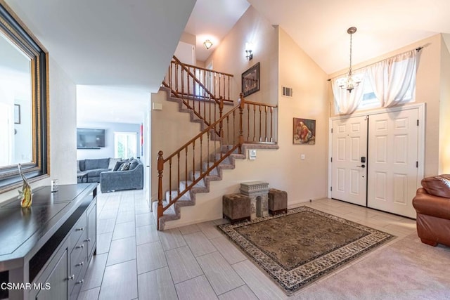 entryway with lofted ceiling and a chandelier