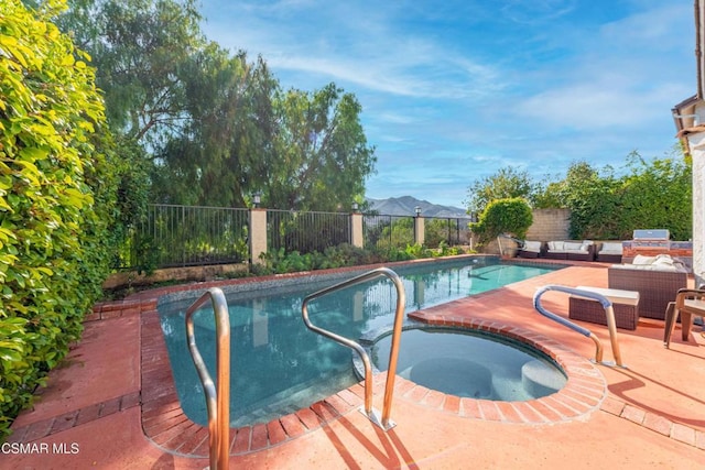 view of swimming pool featuring an in ground hot tub, outdoor lounge area, and a patio area