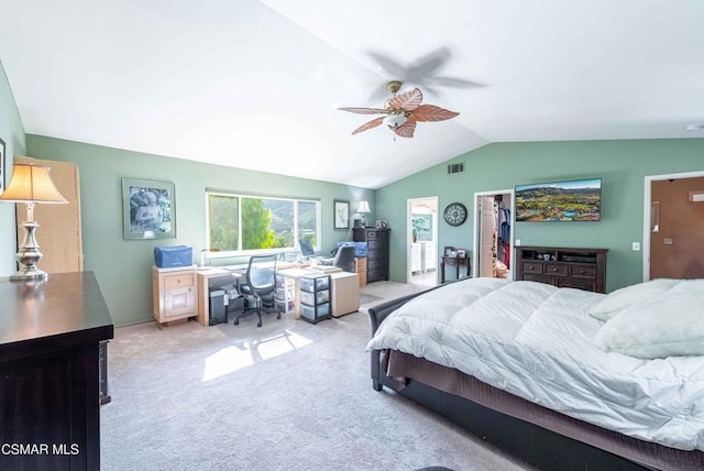 bedroom with a spacious closet, vaulted ceiling, ceiling fan, a closet, and light colored carpet