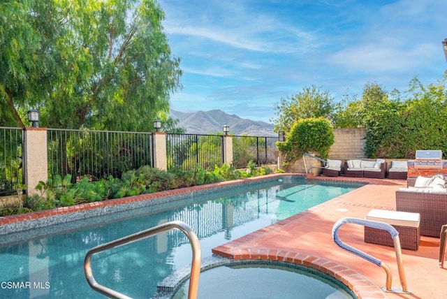 view of swimming pool featuring a mountain view, a patio area, and outdoor lounge area