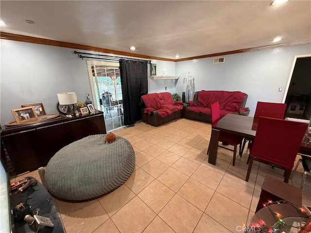 living room with ornamental molding and light tile patterned floors