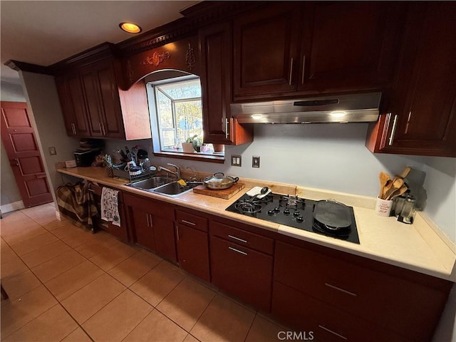 kitchen featuring light tile patterned flooring, black gas stovetop, and sink