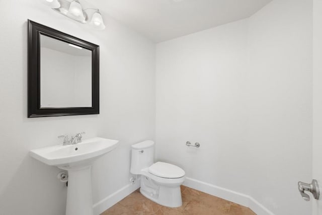 bathroom with tile patterned floors and toilet