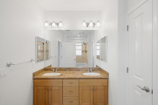 bathroom with vanity and a shower with shower door