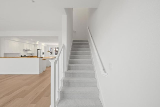 stairway with hardwood / wood-style flooring