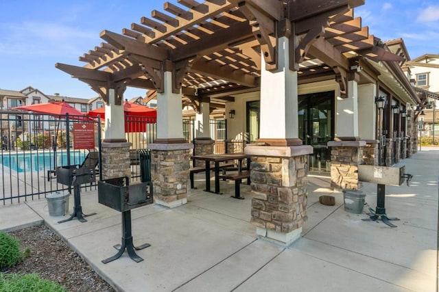 view of patio / terrace with a community pool and a pergola