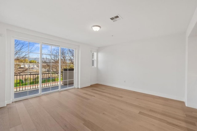 unfurnished room with light hardwood / wood-style flooring