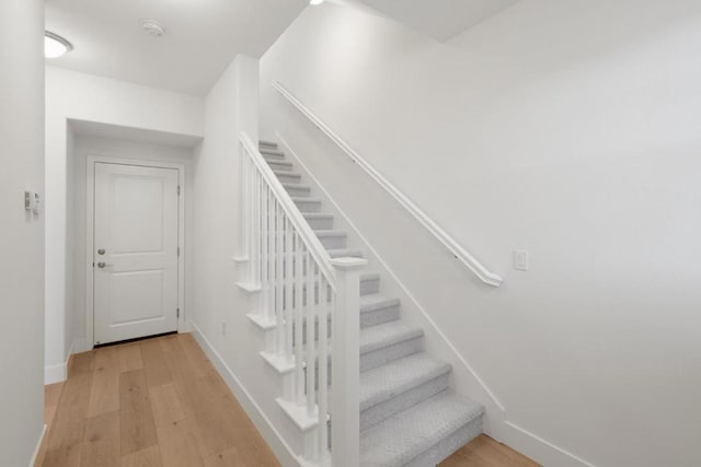 stairs with hardwood / wood-style floors