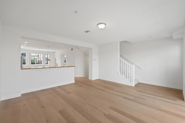 unfurnished living room with light hardwood / wood-style flooring