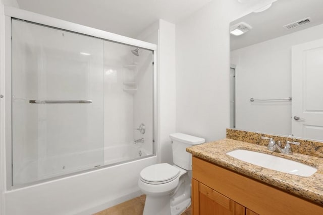 full bathroom with bath / shower combo with glass door, vanity, and toilet