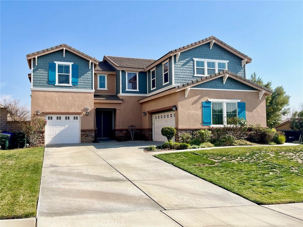 view of front of property with a garage and a front yard