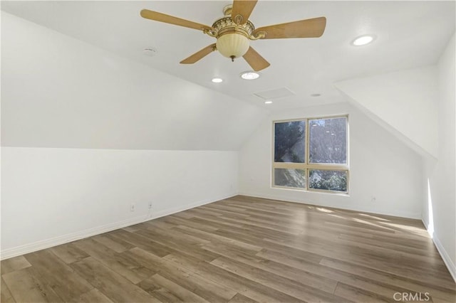 additional living space with attic access, lofted ceiling, recessed lighting, and wood finished floors