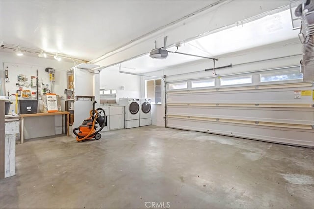 garage featuring separate washer and dryer and a garage door opener