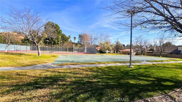 surrounding community with community basketball court, a lawn, and fence