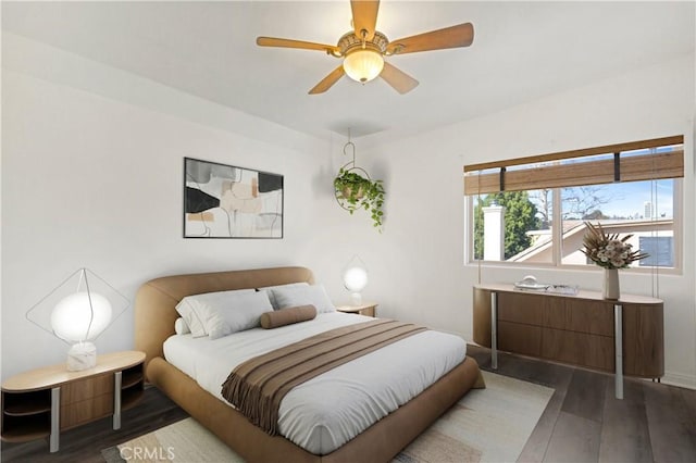 bedroom featuring ceiling fan and dark hardwood / wood-style flooring