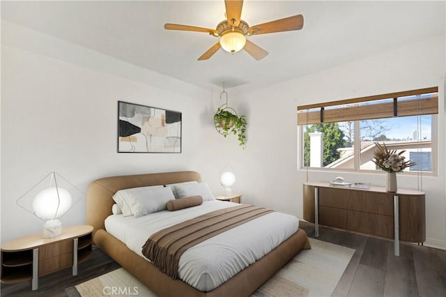 bedroom featuring ceiling fan and dark wood-style flooring