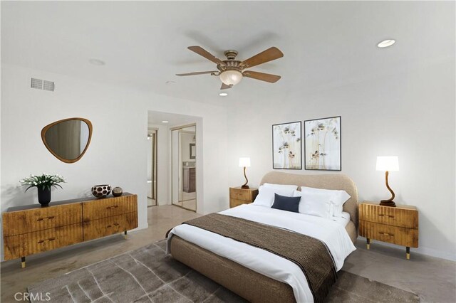 bedroom featuring concrete flooring, ceiling fan, and ensuite bath