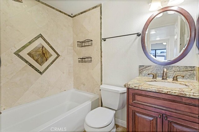 full bathroom with vanity, tiled shower / bath, and toilet