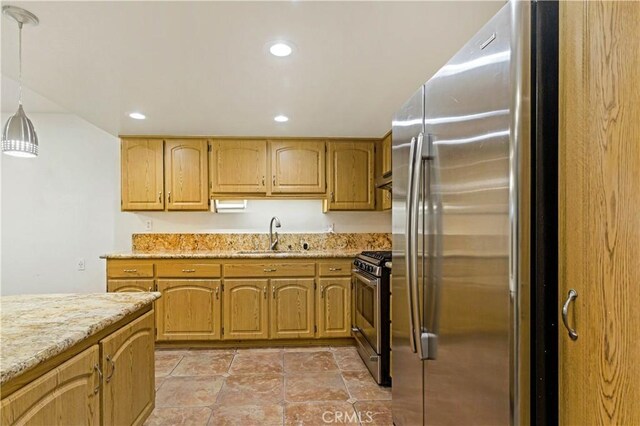 kitchen with stainless steel appliances, sink, pendant lighting, and light stone counters