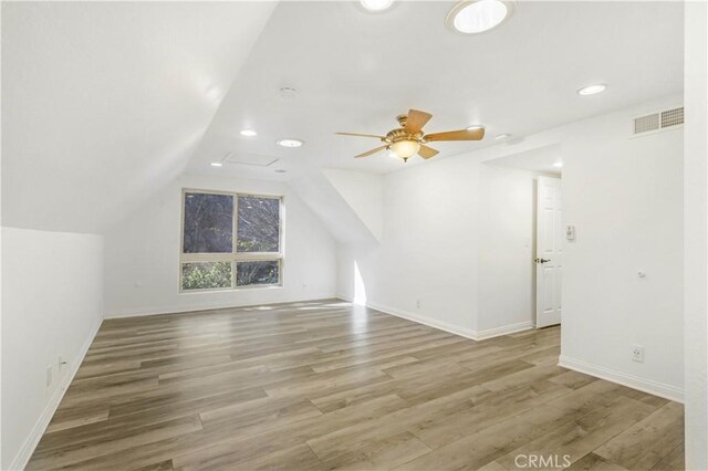 bonus room with hardwood / wood-style flooring, ceiling fan, and lofted ceiling