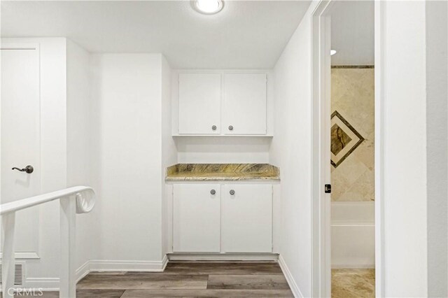 interior space featuring hardwood / wood-style floors and a washtub